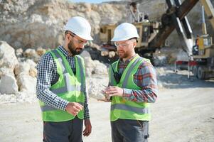 Two workers and quarry in background photo