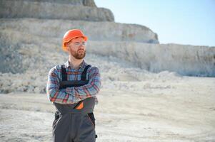 Male worker with bulldozer in sand quarry photo