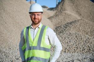 An engineer at a crushed stone or gravel plant. Stone mining photo