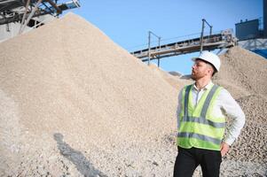 Engineer at the Crushed stone production plant. Gravel photo