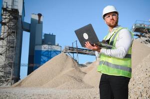 An engineer at a crushed stone or gravel plant. Stone mining photo