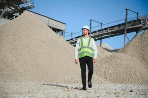 An engineer at a crushed stone or gravel plant. Stone mining photo