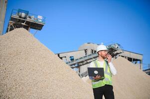 An engineer at a crushed stone or gravel plant. Stone mining photo