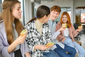 Friendly students having snack at break photo