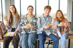 Pupils having lunch in classroom photo