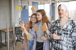 students discuss university assignments together photo