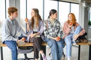 Pupils having lunch in classroom photo