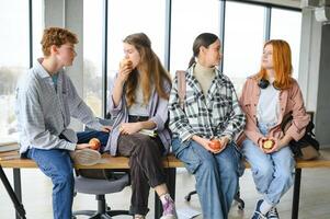 Pupils having lunch in classroom photo