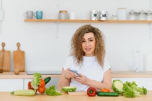Young woman preparing vegetable salad in her kitchen. Healthy lifestyle concept beautiful woman with mixed vegetable. photo