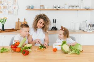 Young woman preparing vegetable salad in her kitchen. Healthy lifestyle concept beautiful woman with mixed vegetable. photo