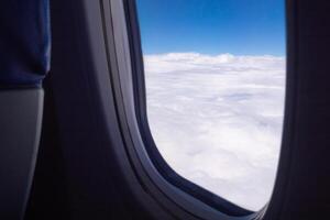 Aerial view of cloudscape seen through airplane window photo