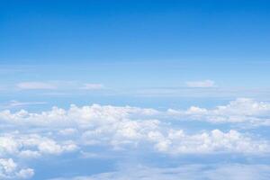 Aerial view of sky and clouds are seen through the airplane window photo
