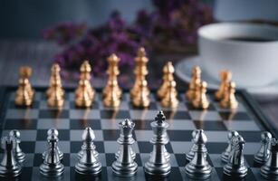 Front view of a chess game on a chessboard with a white coffee cup blur background. Business game competitive strategy. Concept of strategy for business photo