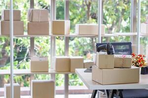 The table in the office has parcel boxes and a barcode reader for prepare delivery to customers. Workspace for e-commerce. Concept of business photo