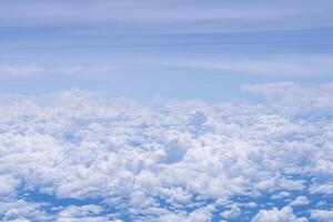 Aerial view of the sky and clouds are seen through the airplane window photo