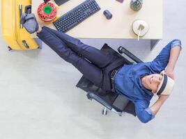 High angle view of a young man sitting on a chair with relaxing at the office photo