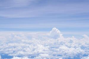 Aerial view of clouds and sky seen through the airplane window photo