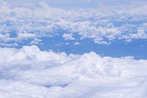 Aerial view of sky and clouds are seen through the airplane Window photo