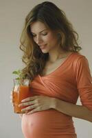 happy pregnant woman drinking green vegetable juice or smoothie at home. photo