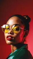 photo of beautiful african woman with style sunglasses standing against red and yellow background,