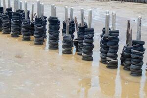 rubber wheel wall protect wave in mangrove forest at Thailand photo