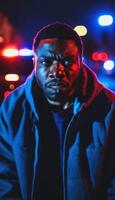 photo of portrait close up view of criminal suspect in crime scene standing in front of police car at night and red blue light,