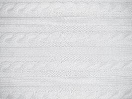 White background horizontal with texture of knitted pattern with pigtail photo