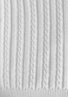 White background vertical with the texture of a knitted pattern with a pigtail with edging photo