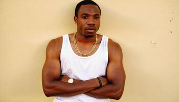 photo of black person man with white tank top in neighborhood ,