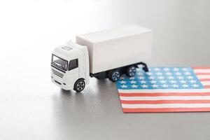 USA Logistics Concept. White Delivery Van on USA Flag background. 3d Rendering. photo