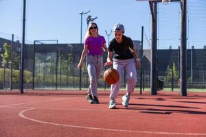 mother and daughter play basketball on a beautiful sunny day. photo