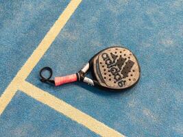 Ukraine Kyiv, May 23 2024. paddle tennis racket and balls on the blue paddle court photo