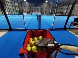 Ukraine Kyiv, April 11 2024. Padel racket adidas and padel ball on a green court photo