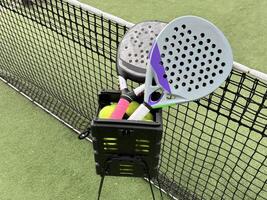 padel tennis racket sport court and balls. photo