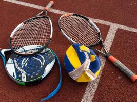 The broken rackets for playing tennis are hanging on the wall of a sports tennis club. photo