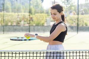 Girl with a racket on the tennis court. photo