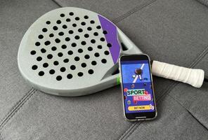 padel tennis and sports betting on a smartphone. Concept of sports bet photo