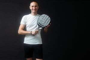 Man ready for paddle tennis serve in studio shot photo