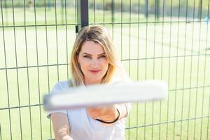 Sportive young girl with racquet playing padel in court. photo