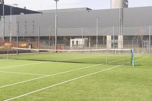 Tennis net on a green field photo