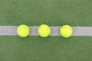 Tennis ball on green grass photo