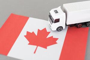 Symbol of National Delivery Truck with Flag of Canada. National Trucking Icon and Canadian flag photo