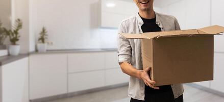 man moving to a new home with box photo