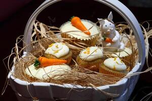 Easter baskets with toys and delicious cupcakes photo