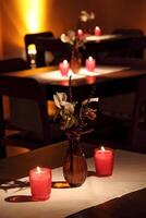 sophisticated party decoration with candles, flowers, tables and specialized lighting photo