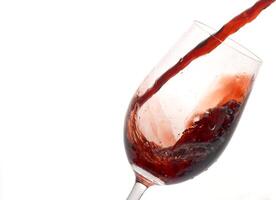 red wine being served in a glass on a white background photo