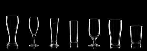 specific beer glasses lined up on black background for comparison photo