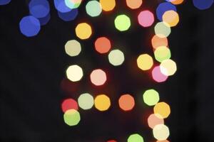 colorful and defocused lights on black background photo