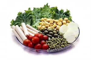 salad with tomatoes, mushrooms, peas, onions and lettuce on white background photo