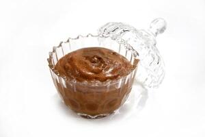 chocolate mousse in glass bowl on white background photo